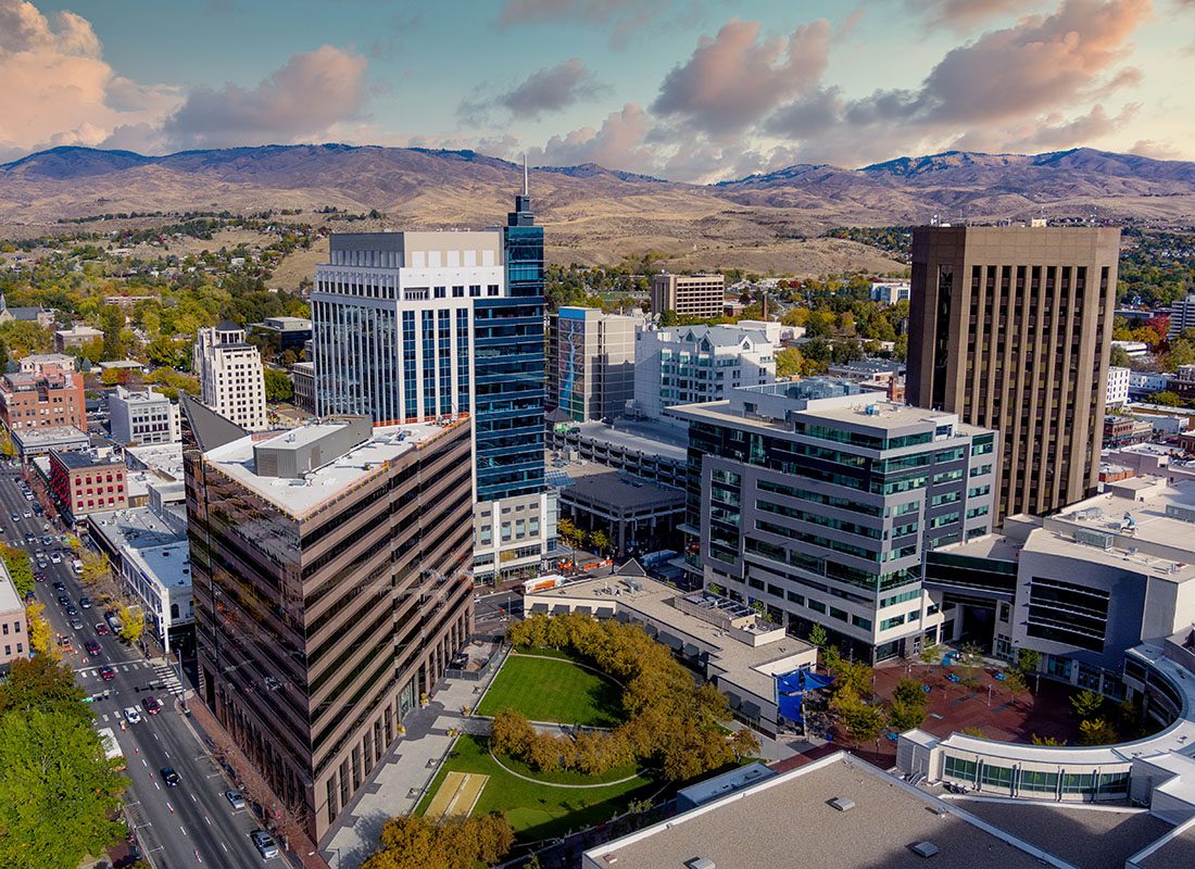 Business Insurance - View of Modern Commercial Buildings in Downtown Boise Idaho Next to a Park with a Cloudy Sunset Sky