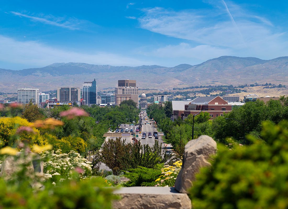 Contact - Green Foliage Surrounding Downtown Boise Idaho Main Street with Mountains in the Background